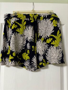 CAbi Navy Floral Drawstring Short with Lime Green Leaves and White Flowers.